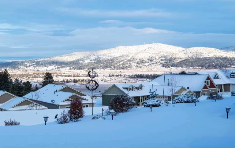 Overlooking Spokane Valley neighborhood homes covered in snow|Lennox air conditioning unit installed outside Spokane Valley home|Honeywell thermostat installed for new HVAC system in Spokane Valley|New Lennox indoor HVAC system installed in Spokane Valley home