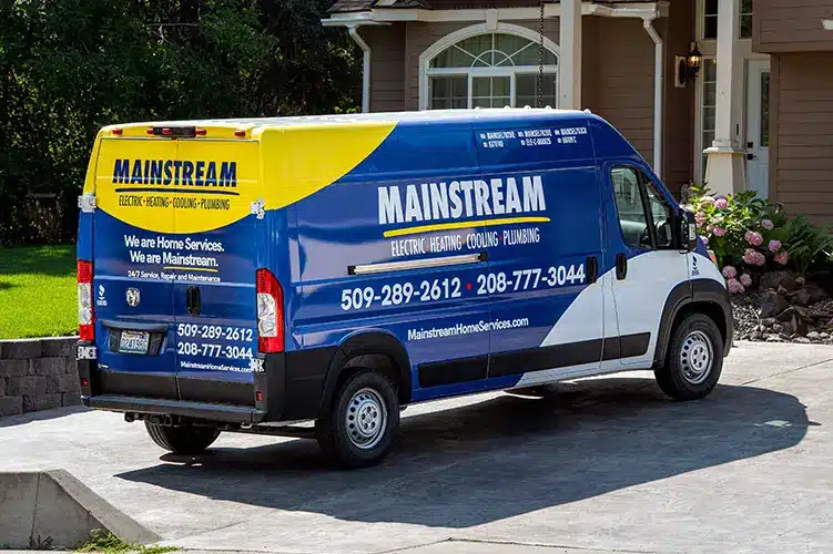 Mainstream service technician with a fully-stocked HVAC and plumbing truck on a Spokane home service call