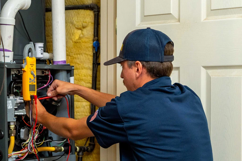 A furnace technician fixing a broken heater