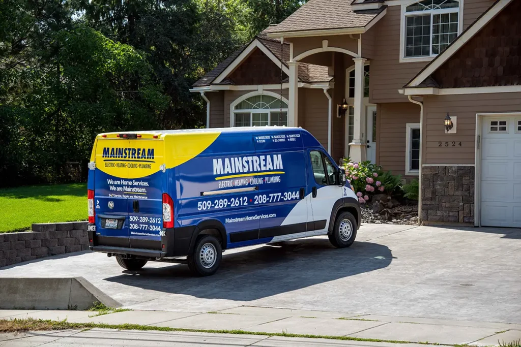 Mainstream comfort advisor explaining a heat pump installation to homeowners