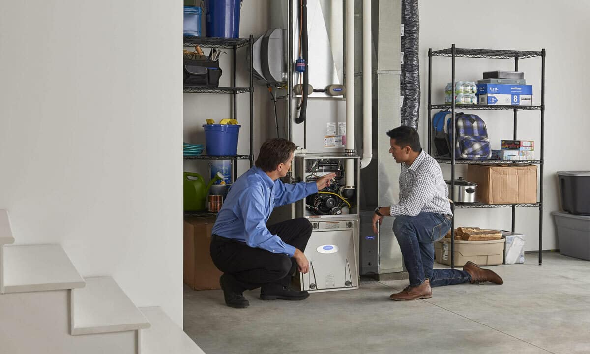 A plumber discussing the hot water heater with the homeowner