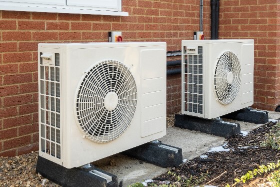 A photo of a heat pump system outside a home