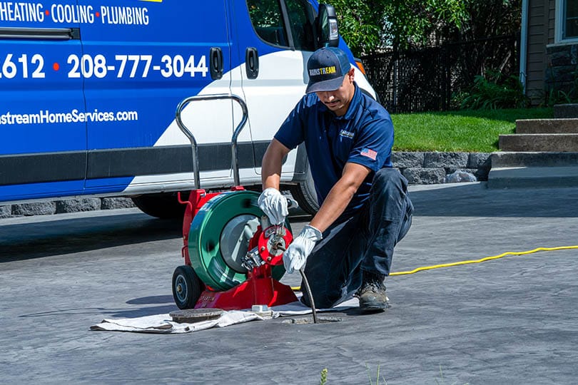 mainstream technician with a sewer and drain cleaning device