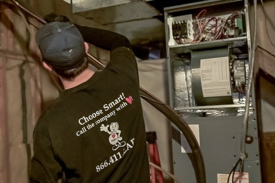 A Mainstream HVAC technician installing a new furnace