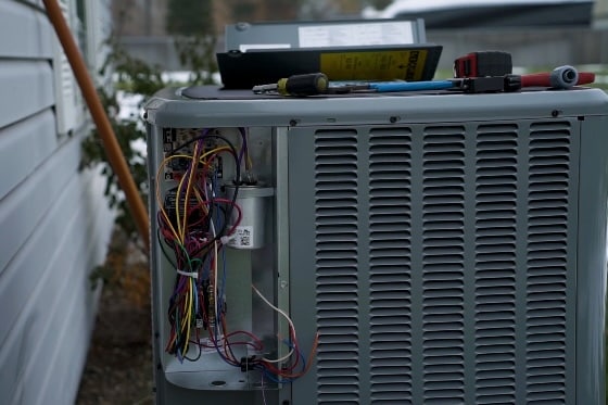 Upclose photo of an air conditioner being repaired