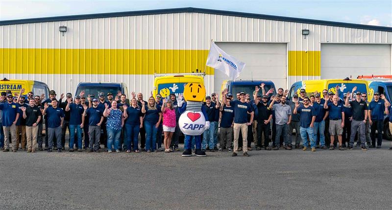 The team at Mainstream with Zapp standing in front of their building