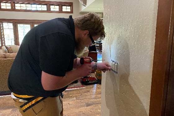 Mainstream Electrician Installing Switch on Wall
