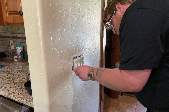 Mainstream Electrician Working on Wall Switch