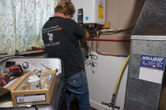 Mainstream Plumber Working on Water Heater