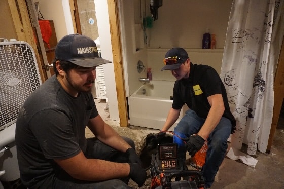 Mainstream Technicians Conducting a Sewer Inspection in Bathroom