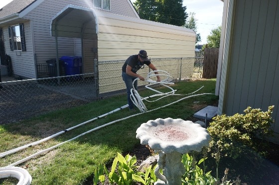 Mainstream Technicians Laying Hoses Out in Yard