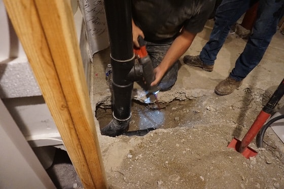 Mainstream Technicians Working on Pipe in Home's Basement