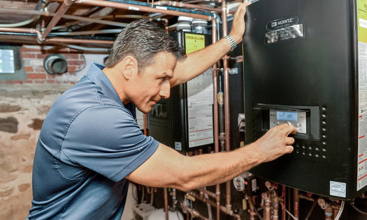 A plumber inspecting a tankless water heater