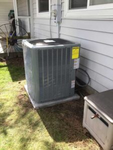 New outdoor AC unit installed on pad next to Spokane Valley home