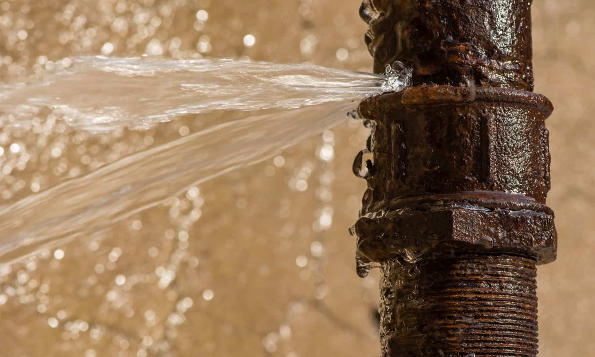 A pipe that has burst and is leaking water