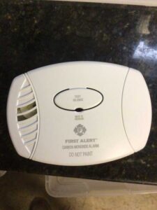 Plug-in carbon monoxide detector installed for home safety during HVAC upgrade
