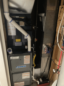 Newly installed indoor furnace and air handler system connected to ductwork in Spokane Valley home