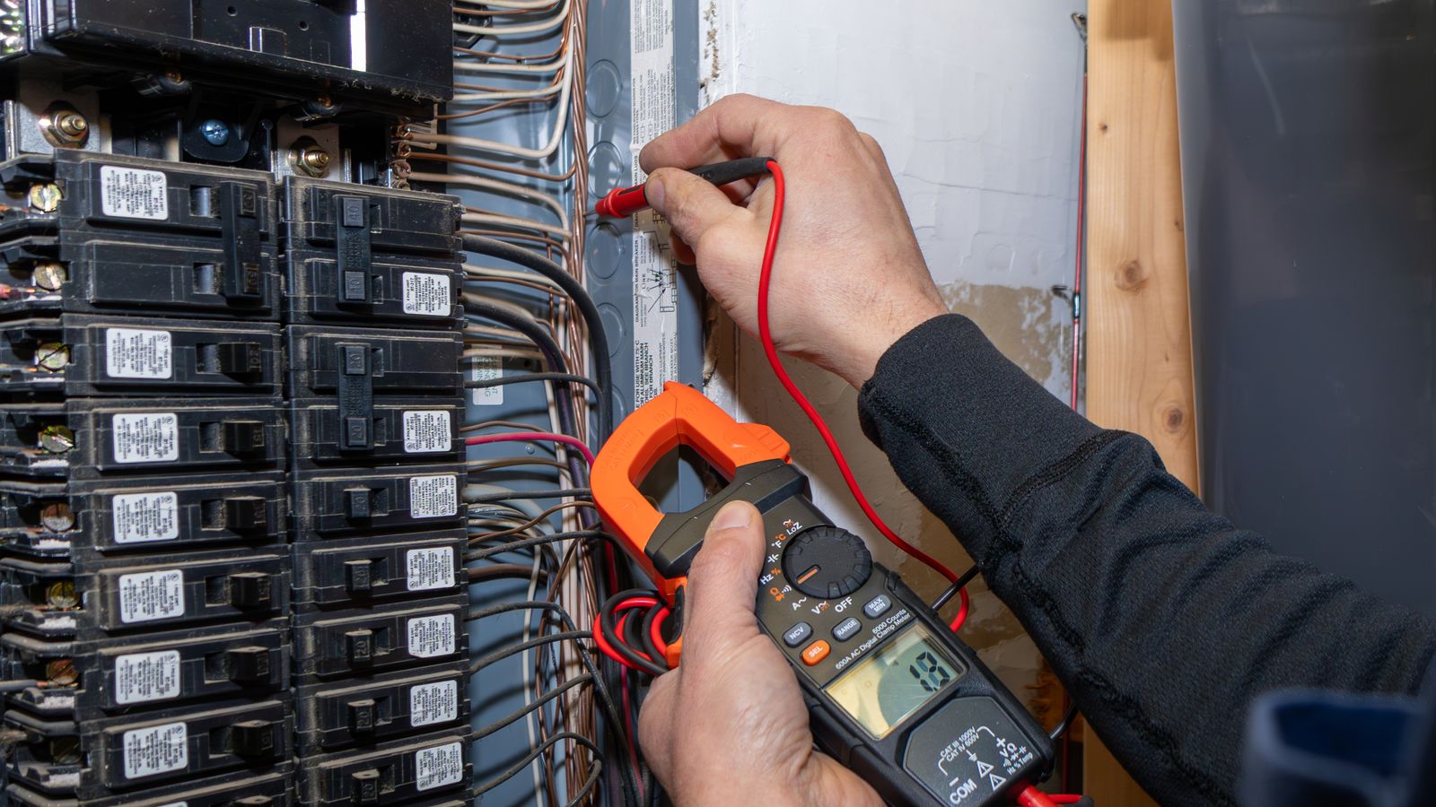 An electrician testing the circuits on an electrical panel