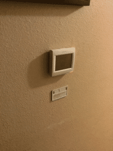 Digital thermostat installed on interior wall for HVAC system control in Spokane home