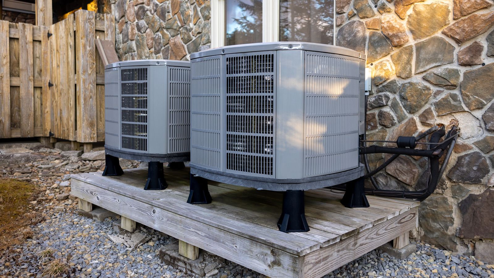 Two AC compressors outside next to home
