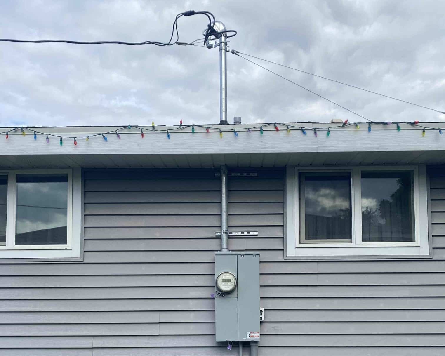 A cropped image to show new mast and electrical box outside a home