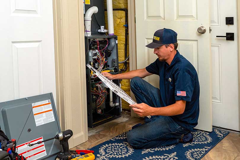 A Mainstream HVAC technician performing a furnace maintenance inspection in Spokane