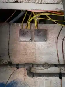 New electrical junction boxes mounted on a basement wall after rewiring