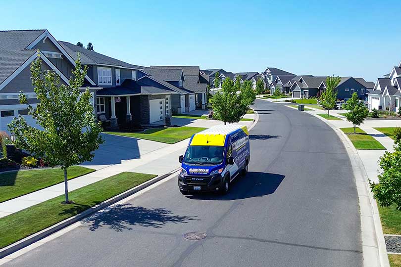 A Mainstream vehicle driving through a Spokane neighborhood
