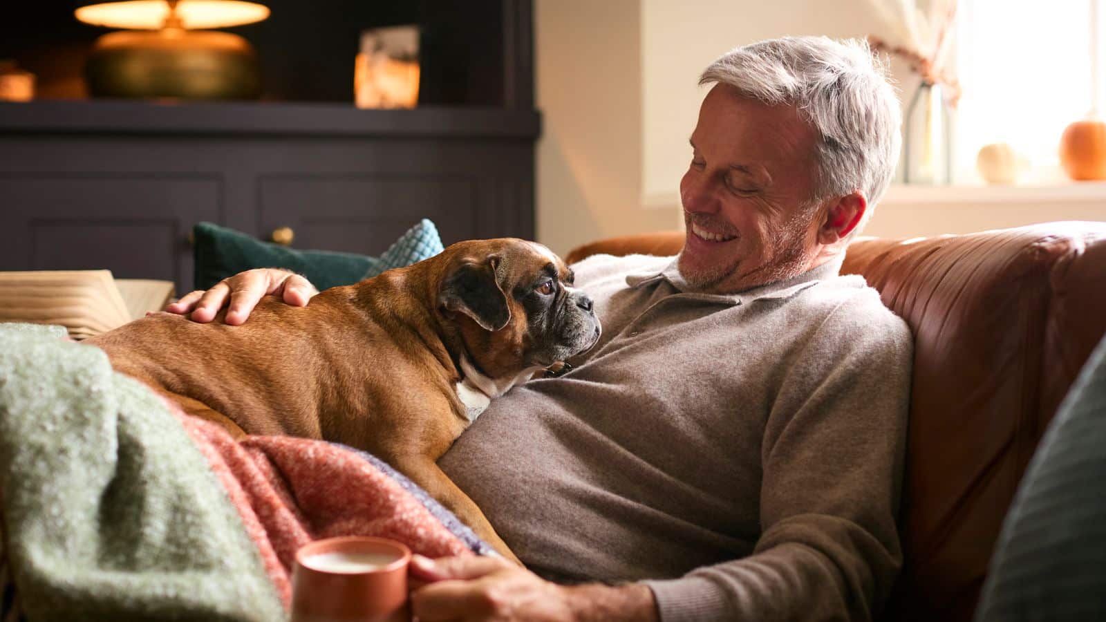 A man with his dog enjoying time in a warm home