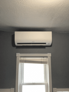 Close-up of ductless mini split indoor unit mounted above window in Cheney WA home