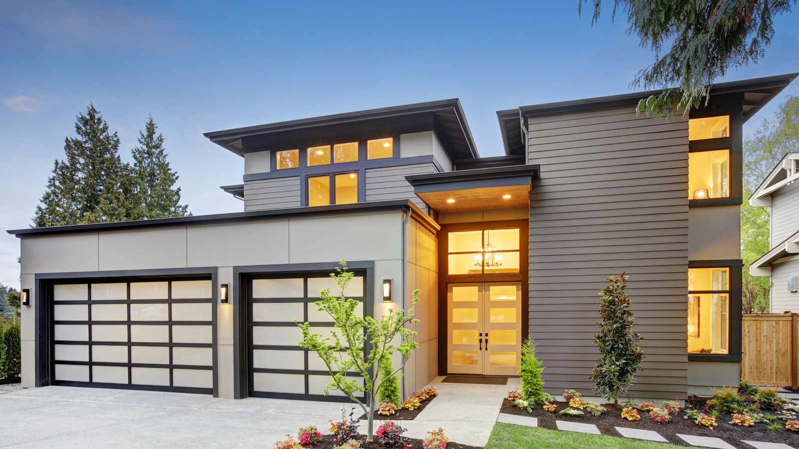 A modern home with its lights on