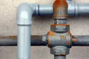 Two types of plumbing pipes and connections up close