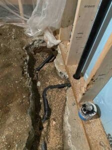 New plumbing lines installed and carefully routed before the concrete floor was repaired.